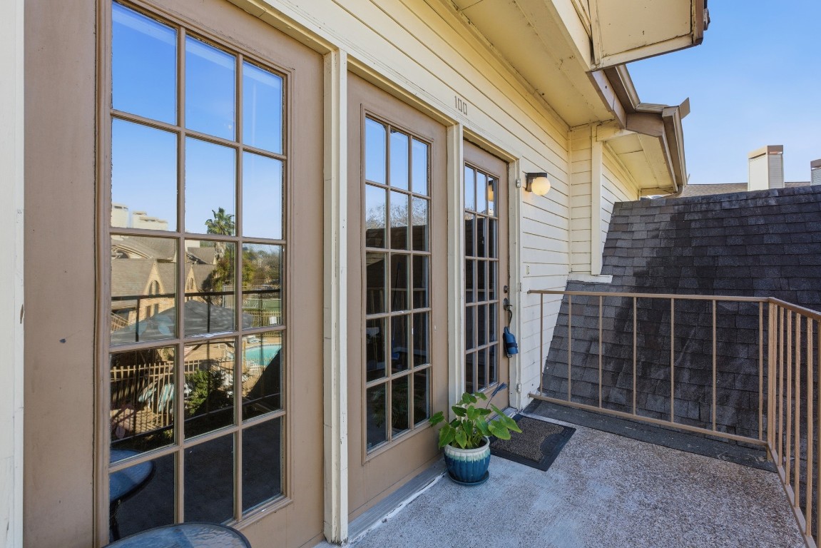 2425 Holly Hall Street, Unit 100 Houston, TX 77054 - Photo 8 of 45 Porch balcony at front door overlooking pool and tennis courts.