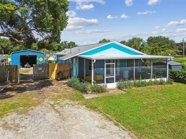 a view of a house with a yard and sitting area