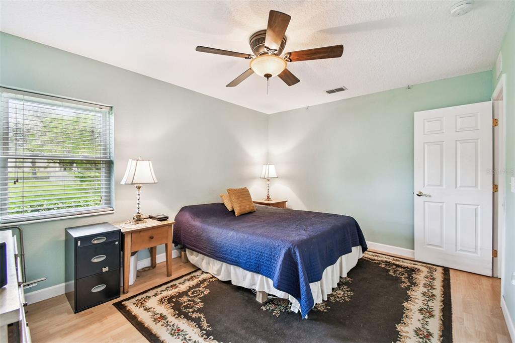 87 Lone Star Street Umatilla, FL 32784 - Photo 31 of 59 a bedroom with a bed and a window