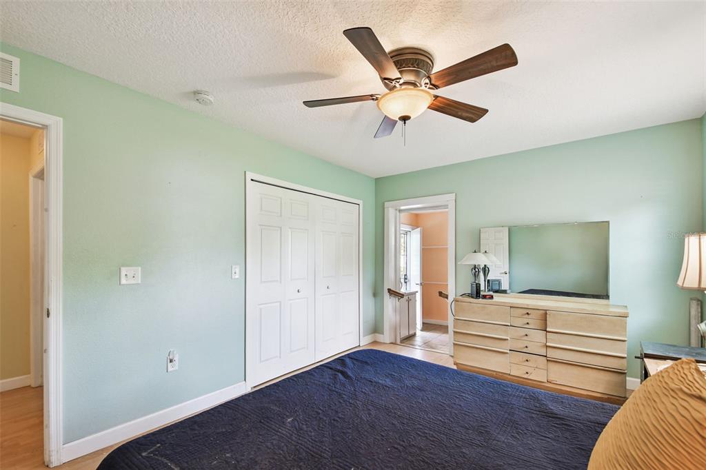 87 Lone Star Street Umatilla, FL 32784 - Photo 32 of 59 a bedroom with a bed and wooden floor