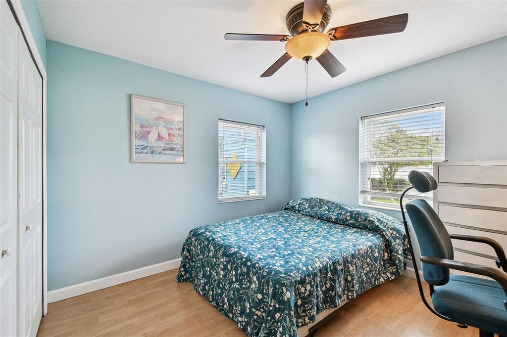 87 Lone Star Street Umatilla, FL 32784 - Photo 33 of 59 a bedroom with a bed and a chandelier