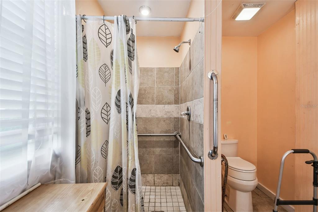 87 Lone Star Street Umatilla, FL 32784 - Photo 38 of 59 a bathroom with a granite countertop shower and a toilet