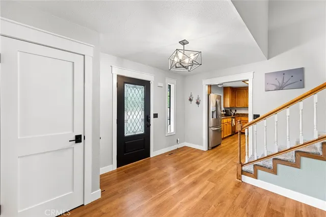 a kitchen with appliances a sink cabinets and a window
