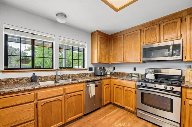 a view of a livingroom with wooden floor and a fireplace