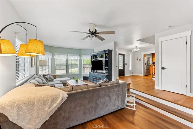 a bathroom with a granite countertop sink toilet a mirror a vanity and shower