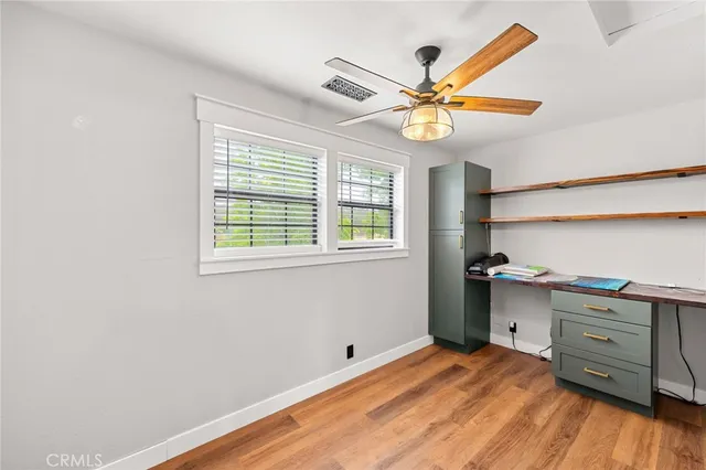 a view of a house with a big yard and a large tree