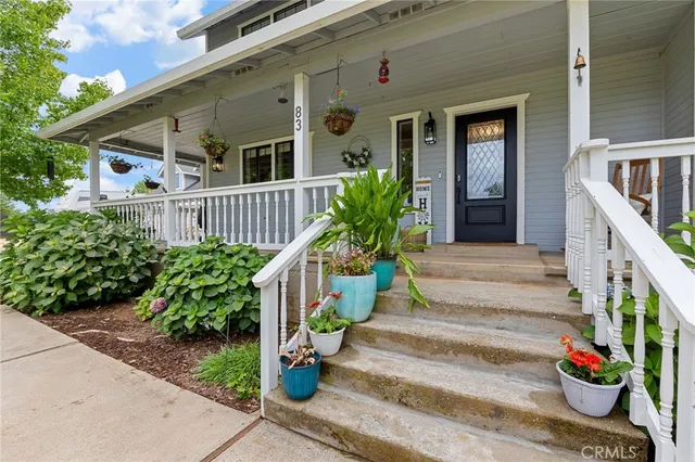 a kitchen with granite countertop a sink cabinets stainless steel appliances and a window