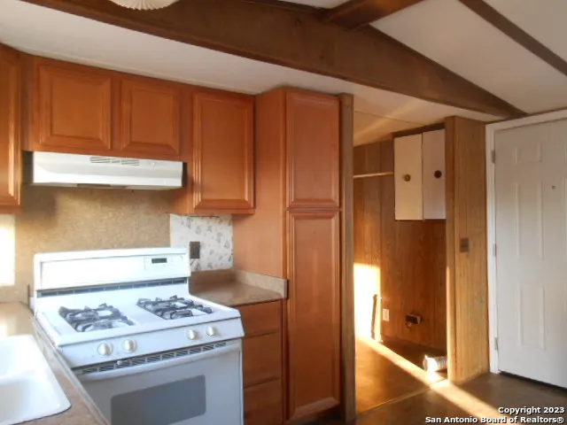 a kitchen with stainless steel appliances granite countertop a stove and a refrigerator