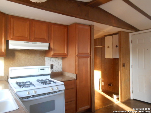 5420 Uecker Road San Antonio, TX 78220 - Photo 16 of 23 a kitchen with stainless steel appliances granite countertop a stove and a refrigerator