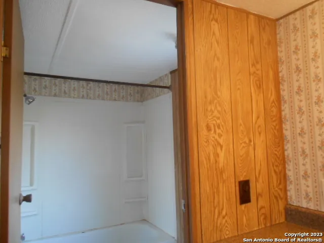 a spacious bathroom with a double vanity sink and a mirror