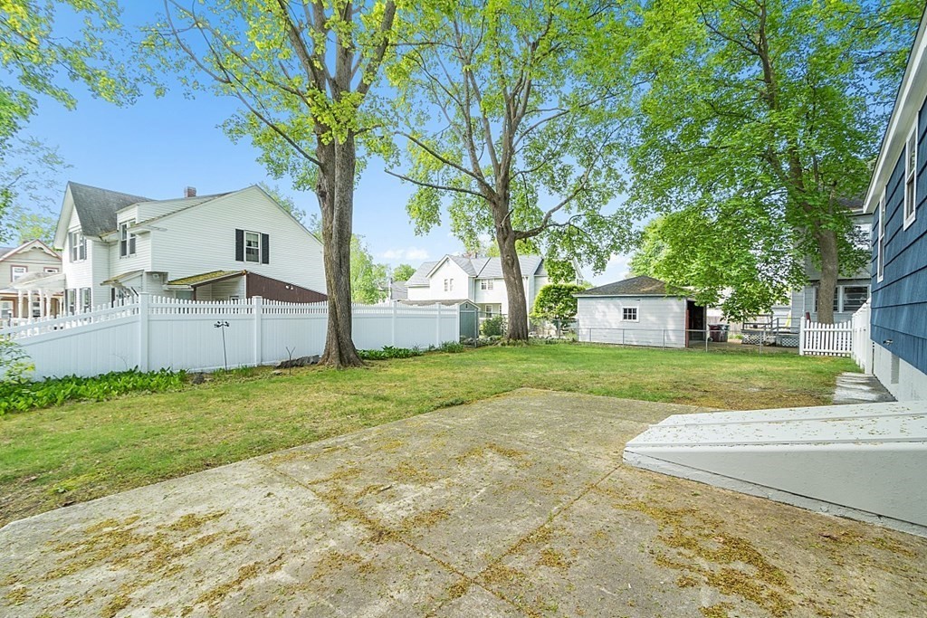 74 Viola Street Lowell, MA 01851 - Photo 11 of 35 a front view of house with yard and trees