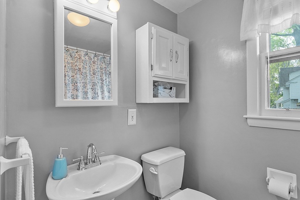 74 Viola Street Lowell, MA 01851 - Photo 18 of 35 a bathroom with a toilet sink and mirror