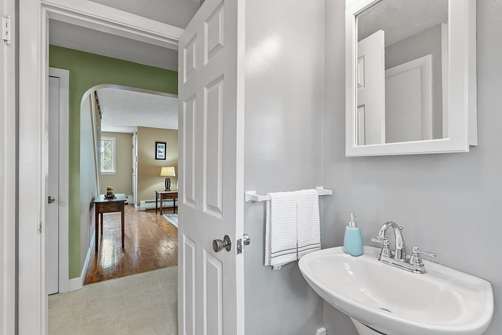 74 Viola Street Lowell, MA 01851 - Photo 19 of 35 a en suite bathroom with a sink and a mirror