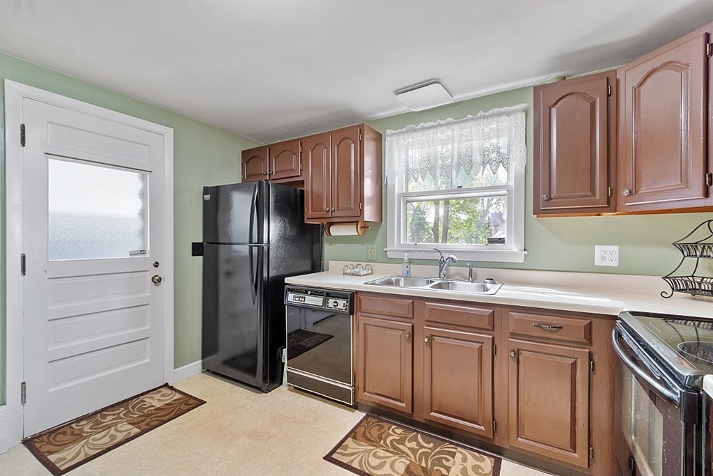 74 Viola Street Lowell, MA 01851 - Photo 20 of 35 a kitchen with a sink stove and refrigerator