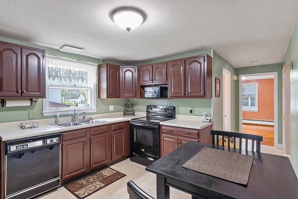 74 Viola Street Lowell, MA 01851 - Photo 21 of 35 a kitchen with a sink stove and cabinets