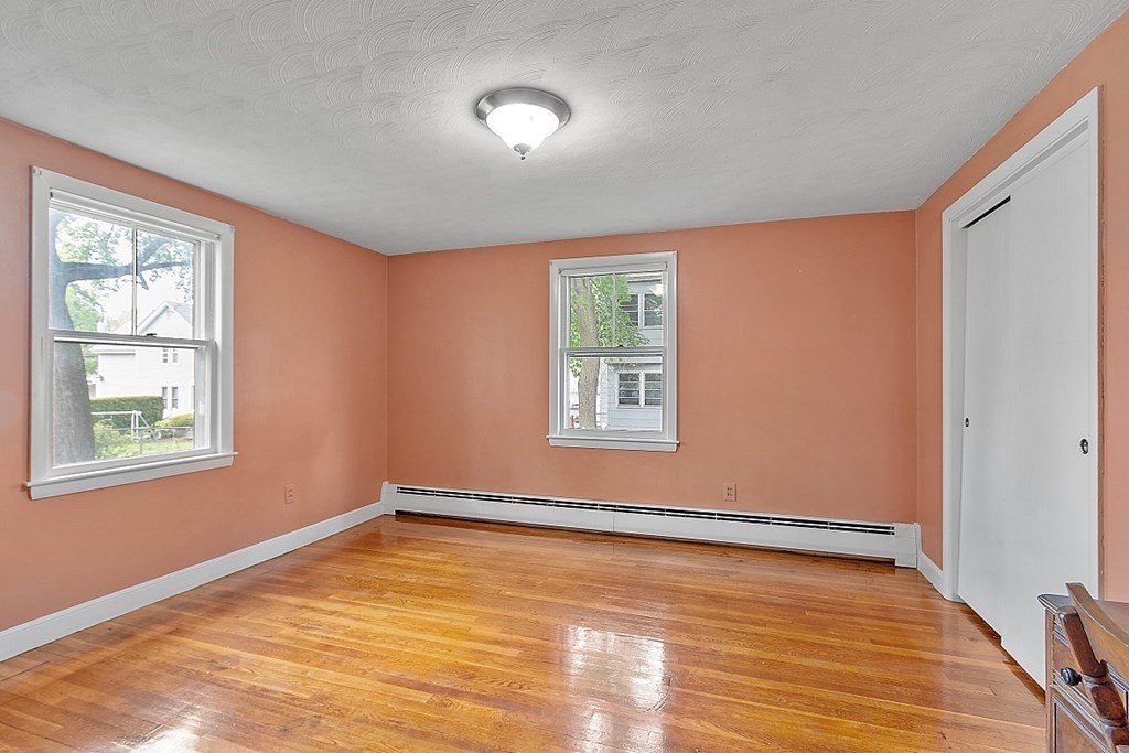74 Viola Street Lowell, MA 01851 - Photo 23 of 35 a view of an empty room with wooden floor and a window