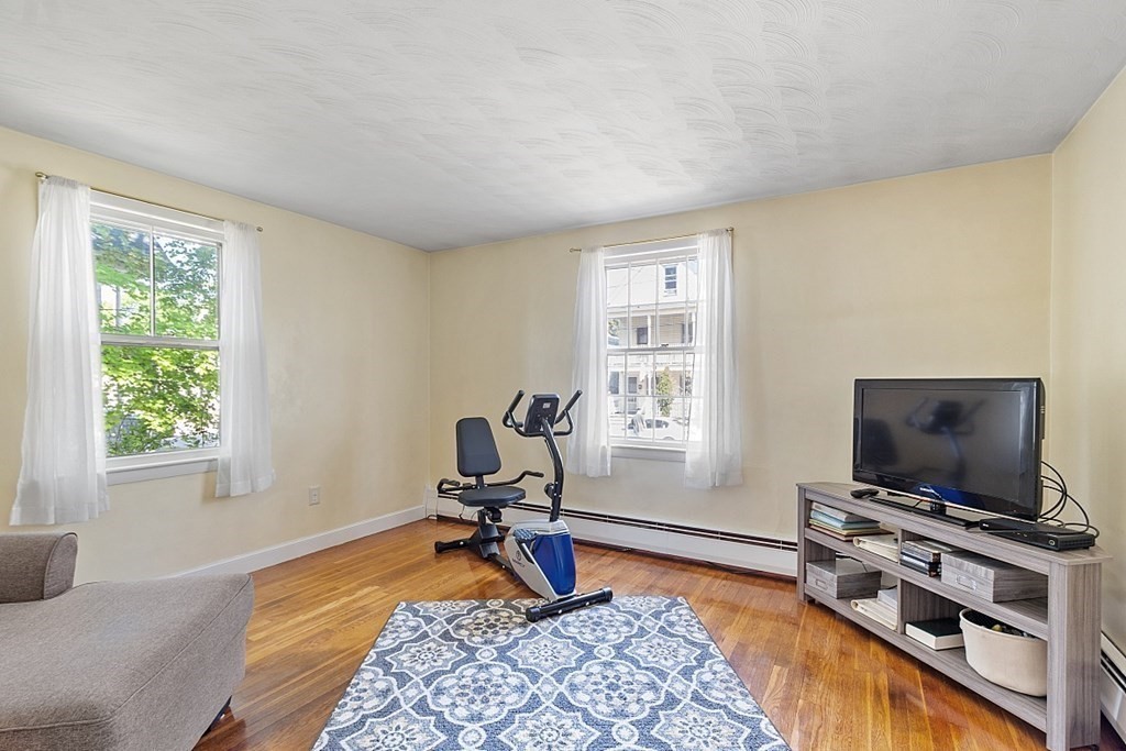 74 Viola Street Lowell, MA 01851 - Photo 24 of 35 a bedroom with furniture and a flat screen tv