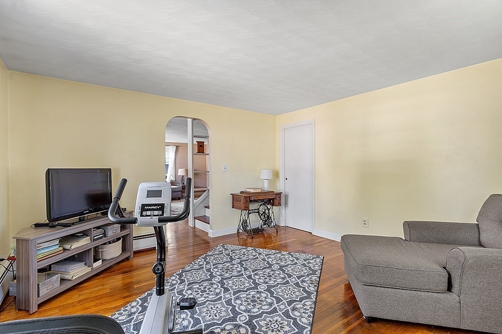74 Viola Street Lowell, MA 01851 - Photo 25 of 35 a living room with furniture and a flat screen tv