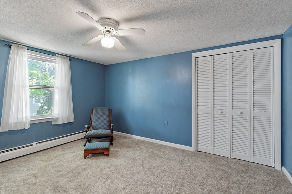 74 Viola Street Lowell, MA 01851 - Photo 30 of 35 an empty room with windows and ceiling fan