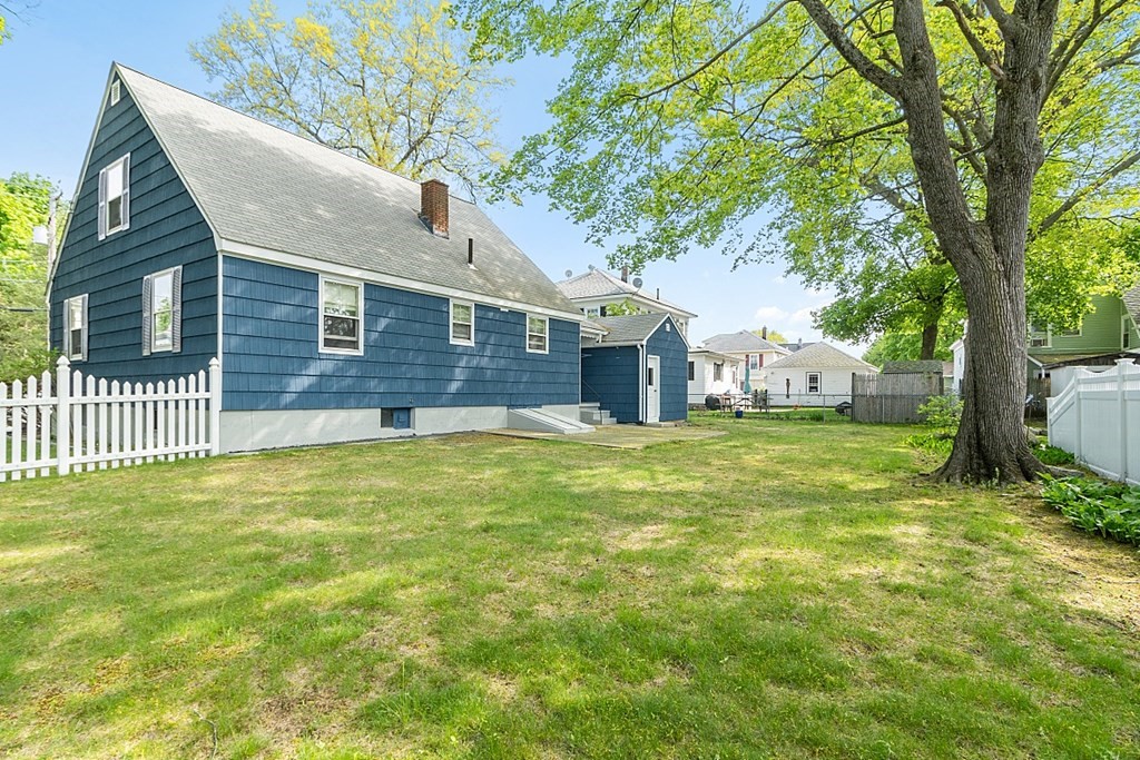 74 Viola Street Lowell, MA 01851 - Photo 7 of 35 a front view of house with yard and green space