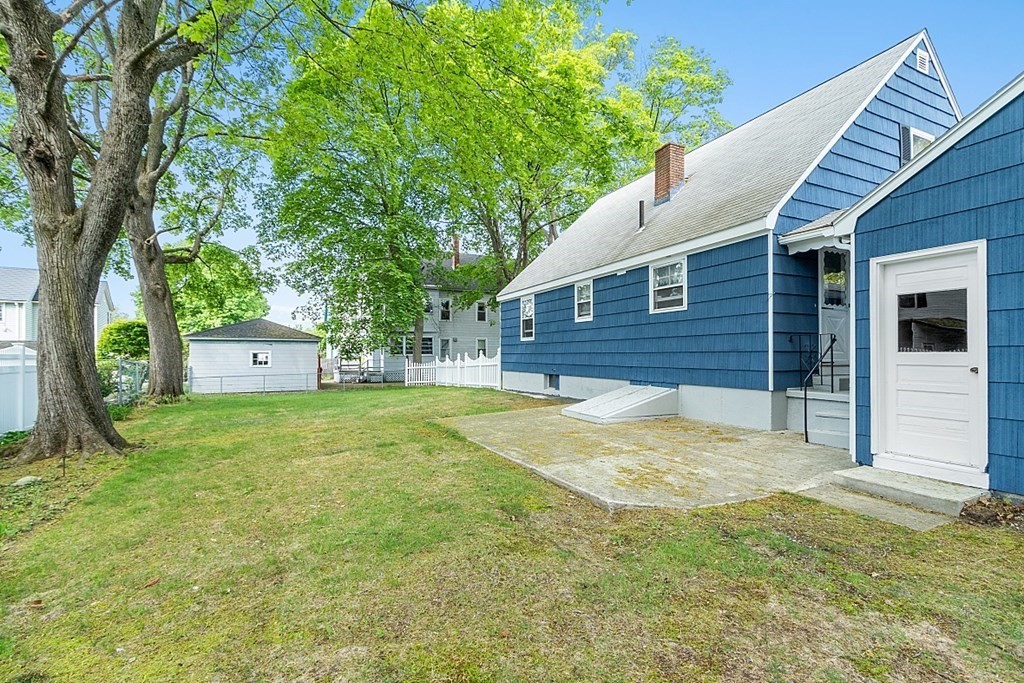 74 Viola Street Lowell, MA 01851 - Photo 10 of 35 a view of backyard of house with green space