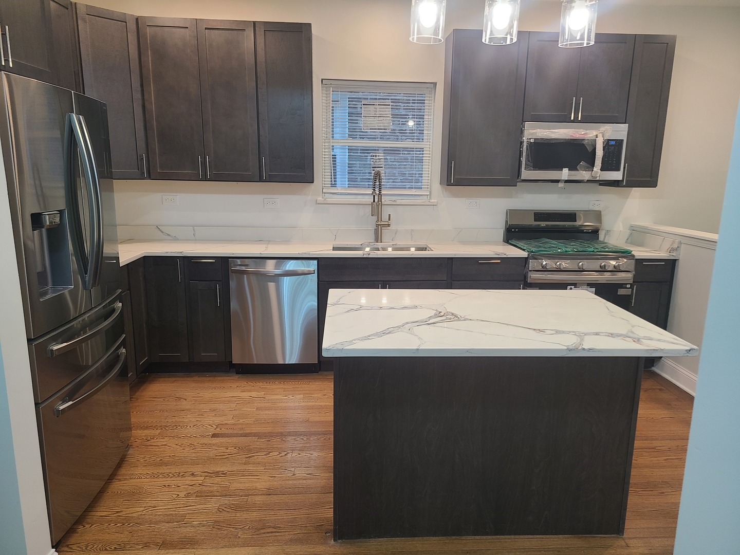 7744 South Champlain Avenue Chicago, IL 60619 - Photo 11 of 21 a kitchen with stainless steel appliances granite countertop a sink stove and refrigerator