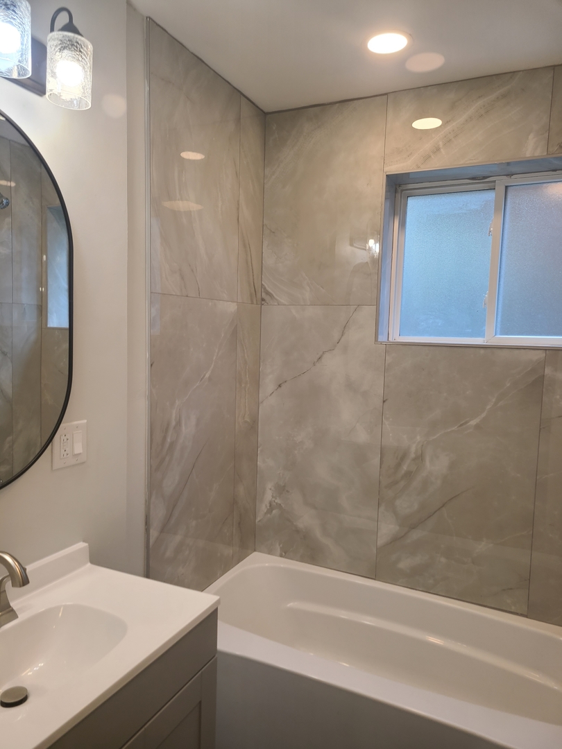 7744 South Champlain Avenue Chicago, IL 60619 - Photo 12 of 21 a bathroom with a sink and a mirror
