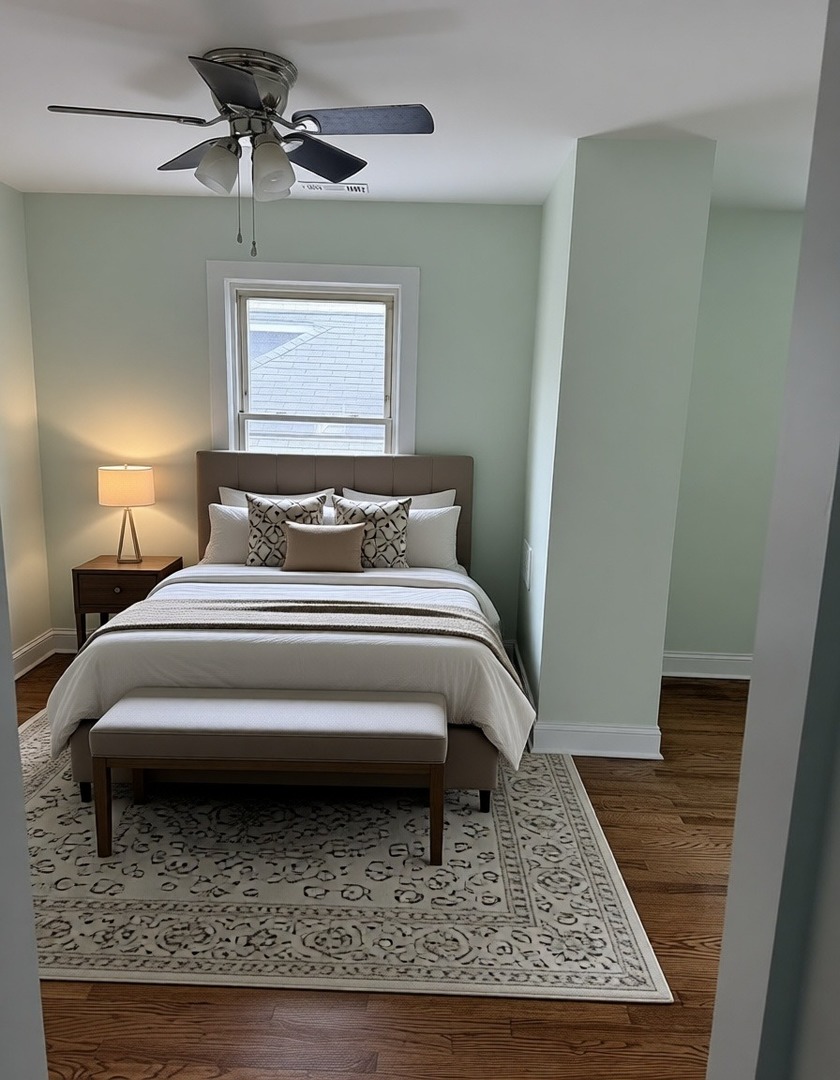 7744 South Champlain Avenue Chicago, IL 60619 - Photo 16 of 21 a bedroom with a bed rug and wooden floor