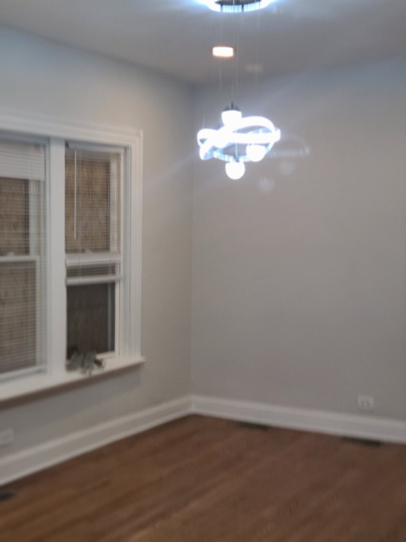 7744 South Champlain Avenue Chicago, IL 60619 - Photo 8 of 21 a view of an empty room with a window
