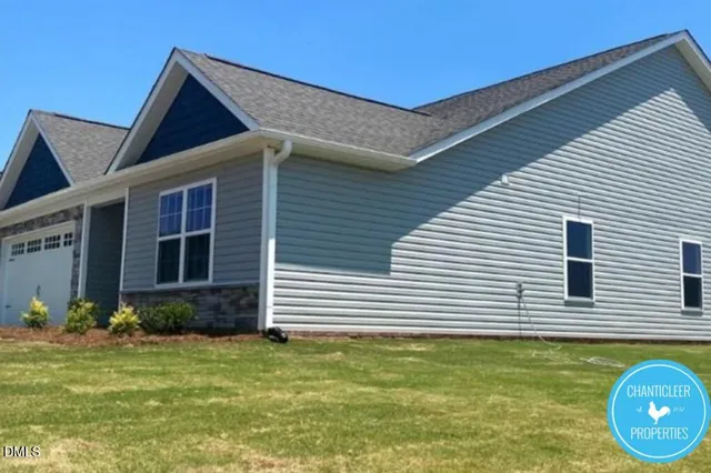 a view of a house with a backyard