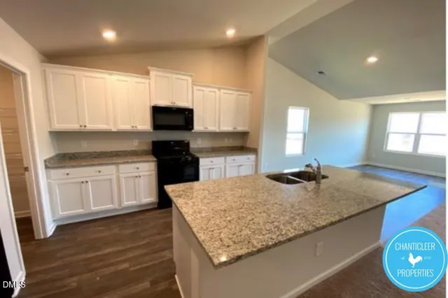 a kitchen with kitchen island granite countertop wooden cabinets and a granite counter tops
