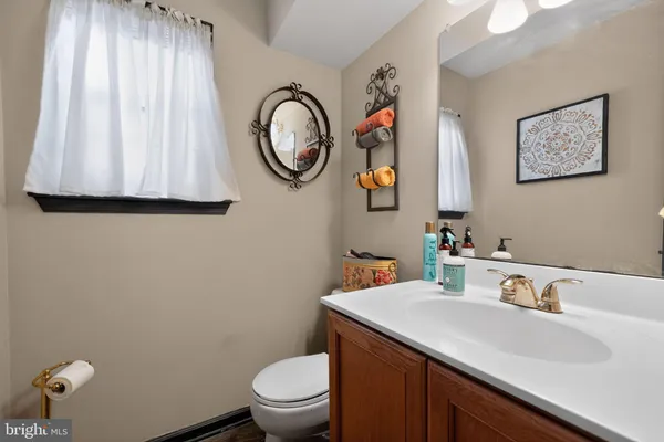 a bathroom with a toilet sink and mirror
