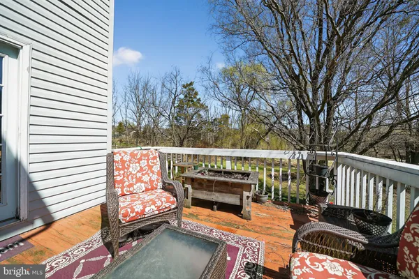 a balcony with furniture and wooden floor