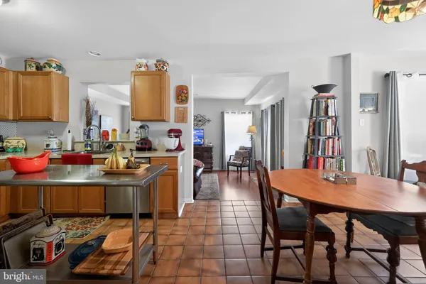 a living room with furniture a flat screen tv and a dining table