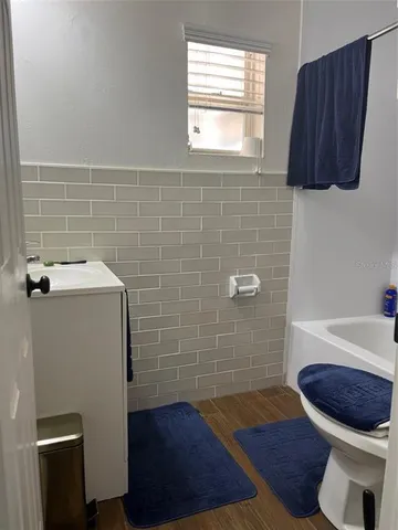 a bathroom with a sink a toilet and bathtub