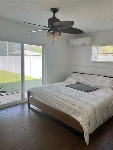 a bedroom with a bed and a large window