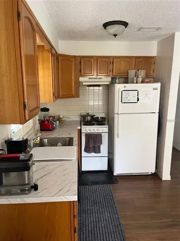 a kitchen with a refrigerator and a stove