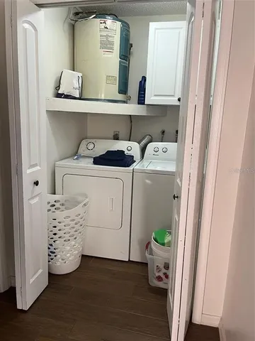 a view of washer and dryer with wooden floor