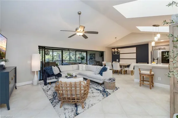 a living room with furniture ceiling fan and a rug
