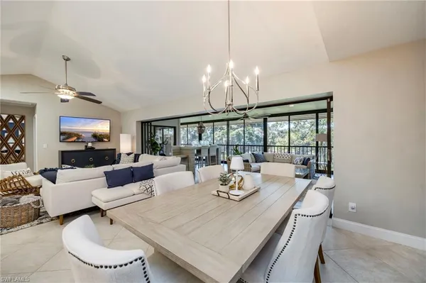 a view of a dining room with furniture large windows and wooden floor