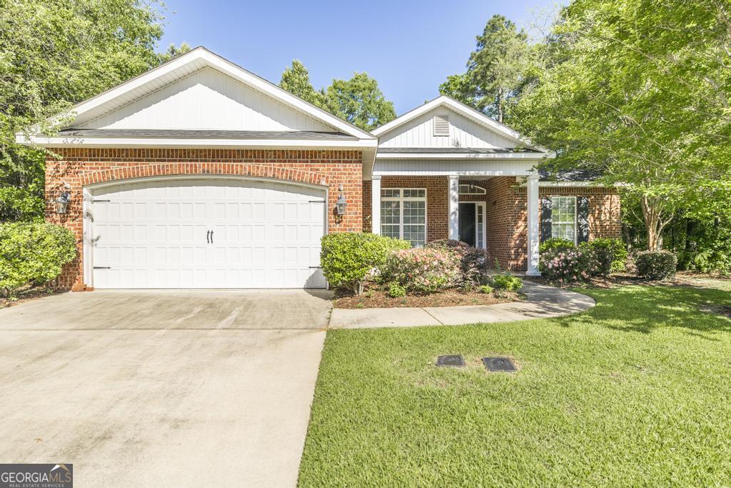 206 Londe Lane Perry, GA 31069 - Photo 2 of 37 a front view of a house with a yard and garage