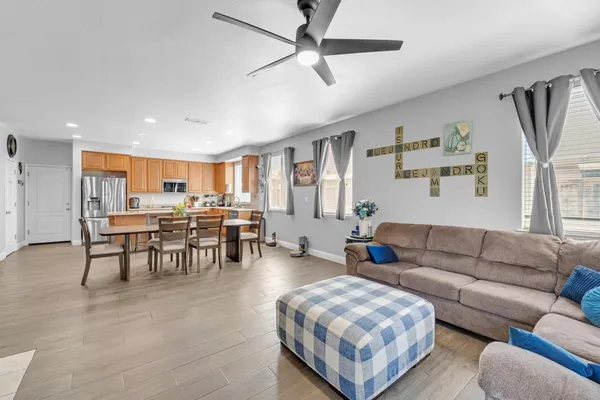 a living room with furniture a fireplace and kitchen view