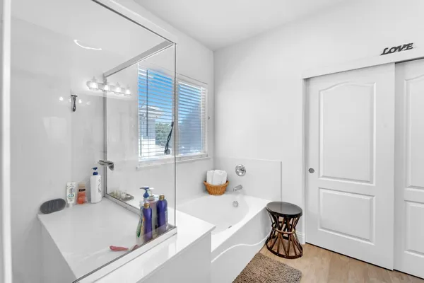 a view of a hallway with wooden floor and closet
