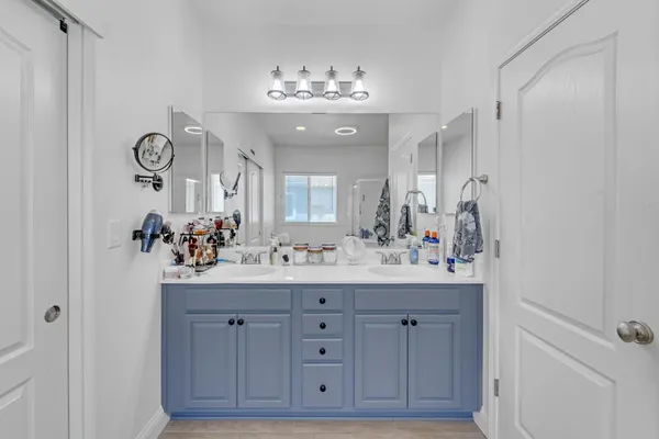 a bathroom with a tub a window and a shower