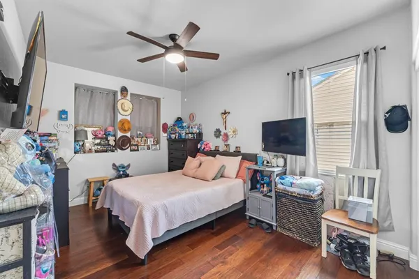 a bathroom with a granite countertop toilet sink and mirror