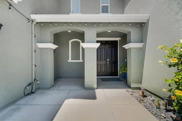 a living room with furniture and kitchen view