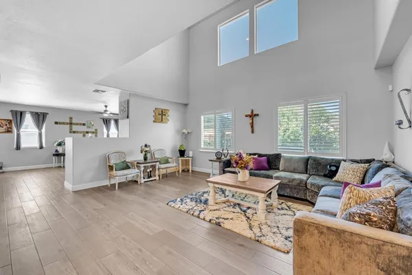 a living room with furniture and a chandelier