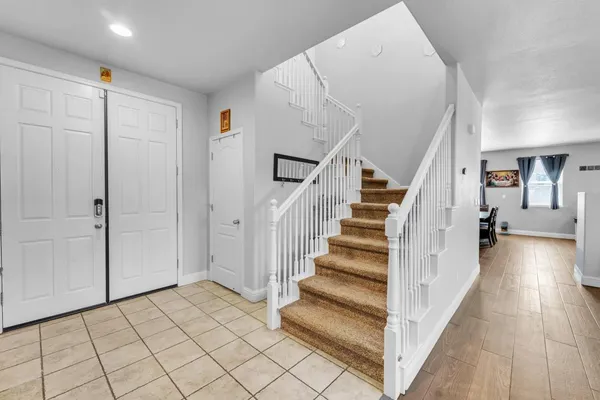a view of a livingroom with furniture and staircase