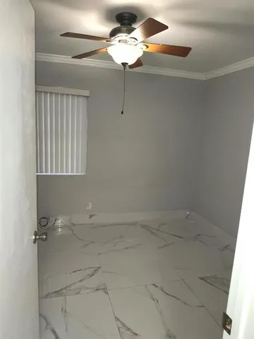 a bathroom with a light fixture a sink and a window