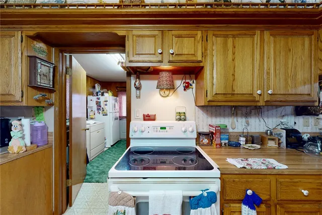 a kitchen with stainless steel appliances granite countertop a stove and cabinets